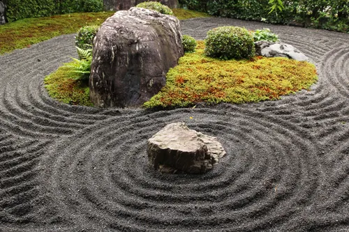 Concentric raked sand patterns around stones, Kyoto-style dry garden